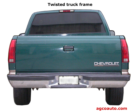 A pickup truck, seen from the rear and with a severely twisted frame