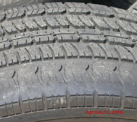 A tire showing wear from improper wheel alignment.